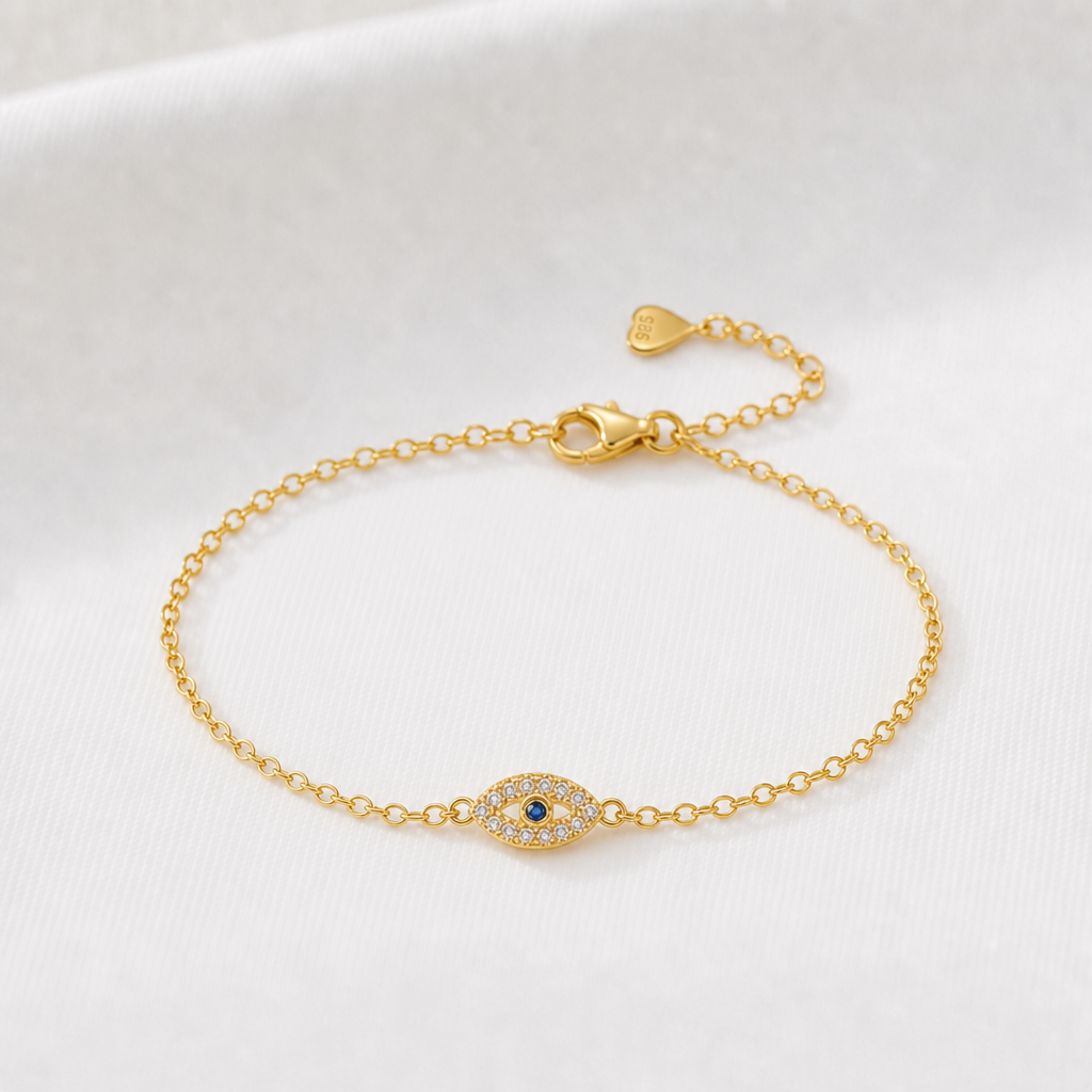 Guldarmband med evil eye i blått och klara stenar