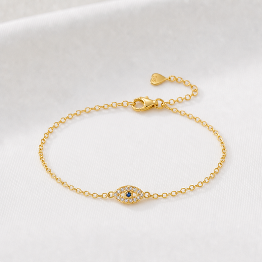 Guldarmband med evil eye i blått och klara stenar